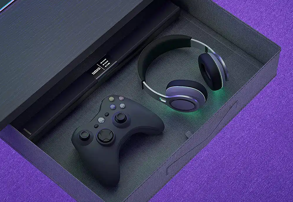 Drawer of the CubiCubi L-shaped gaming desk. Inside there is a headset, a game controller and a sound bar.
