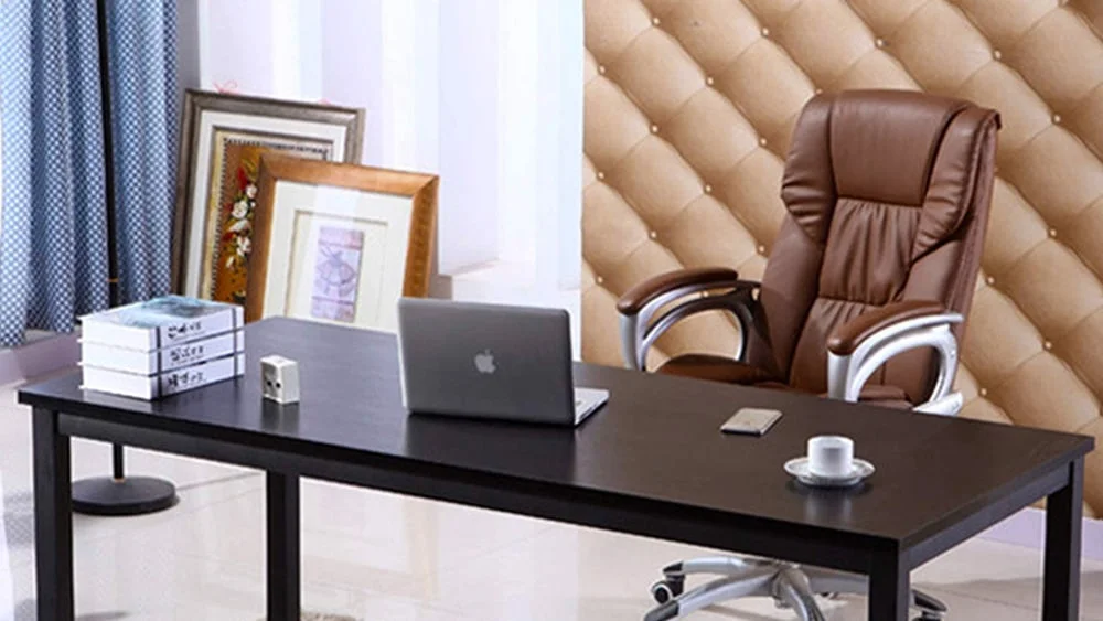 Executive desk with a laptop computer, a few books and other stuff on it.