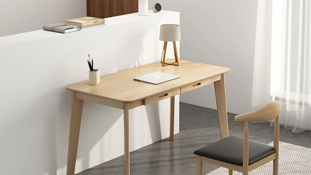 Escritorio para escribir, con un ordenador port&aacute;til encima y situado en una habitaci&oacute;n de casa 